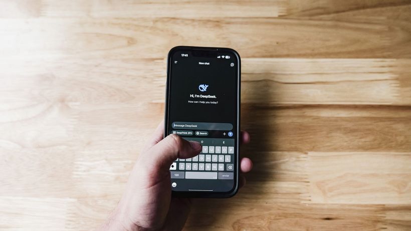 A person interacting with an AI assistant on a smartphone indoors