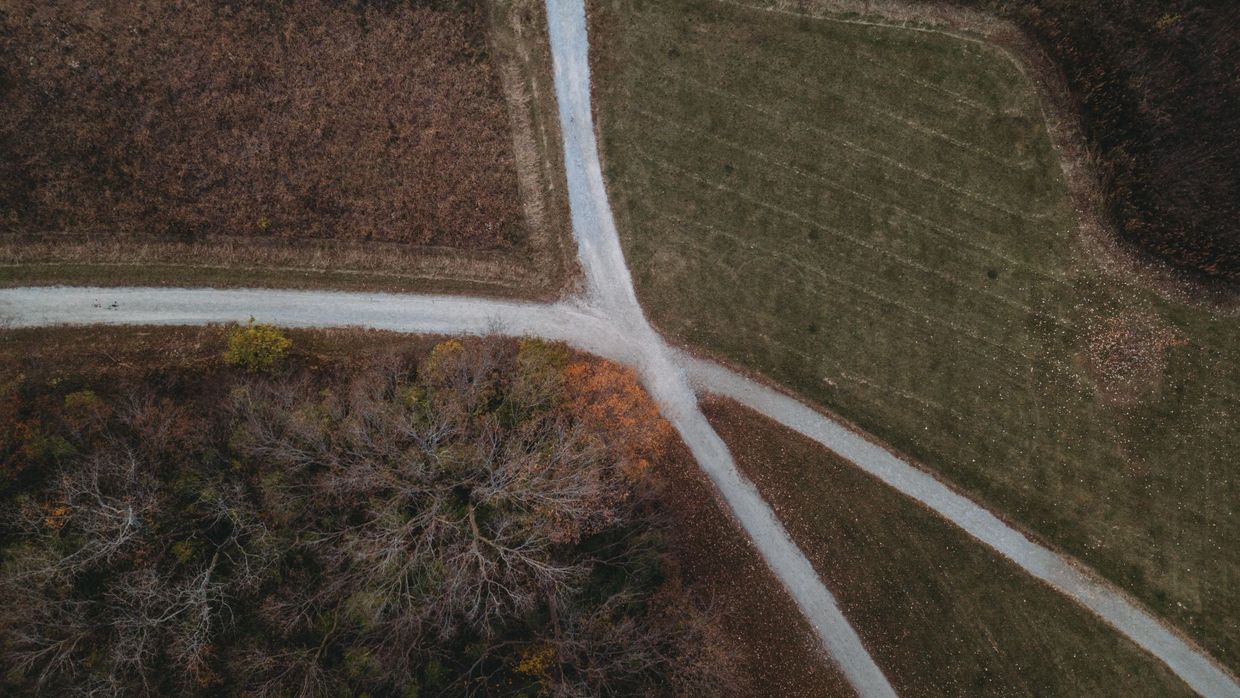 Changing career into SEO: aerial view capturing a rural road intersection amidst a fall landscape with barren trees