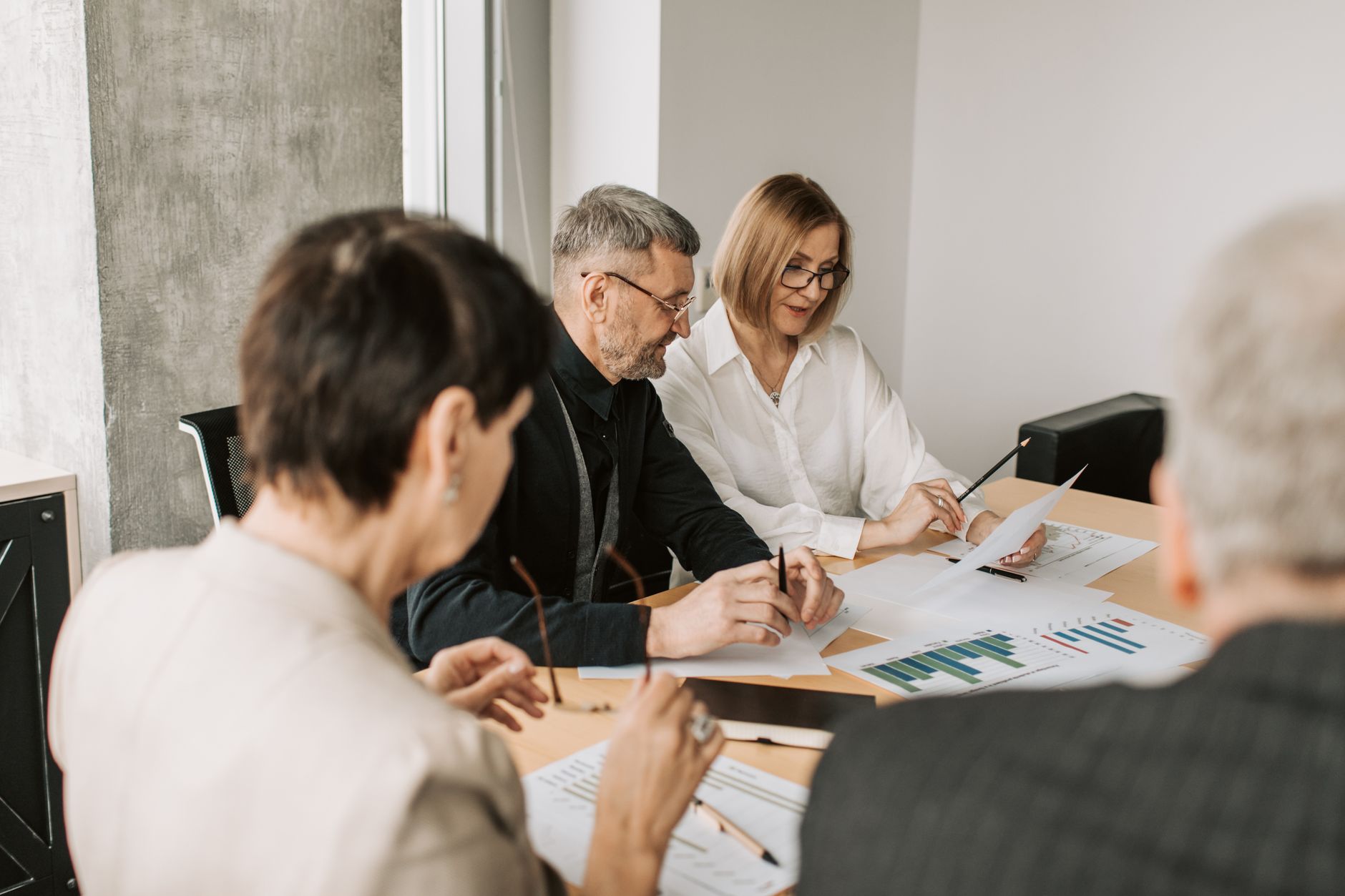SEO professionals discussing performance charts in a meeting
