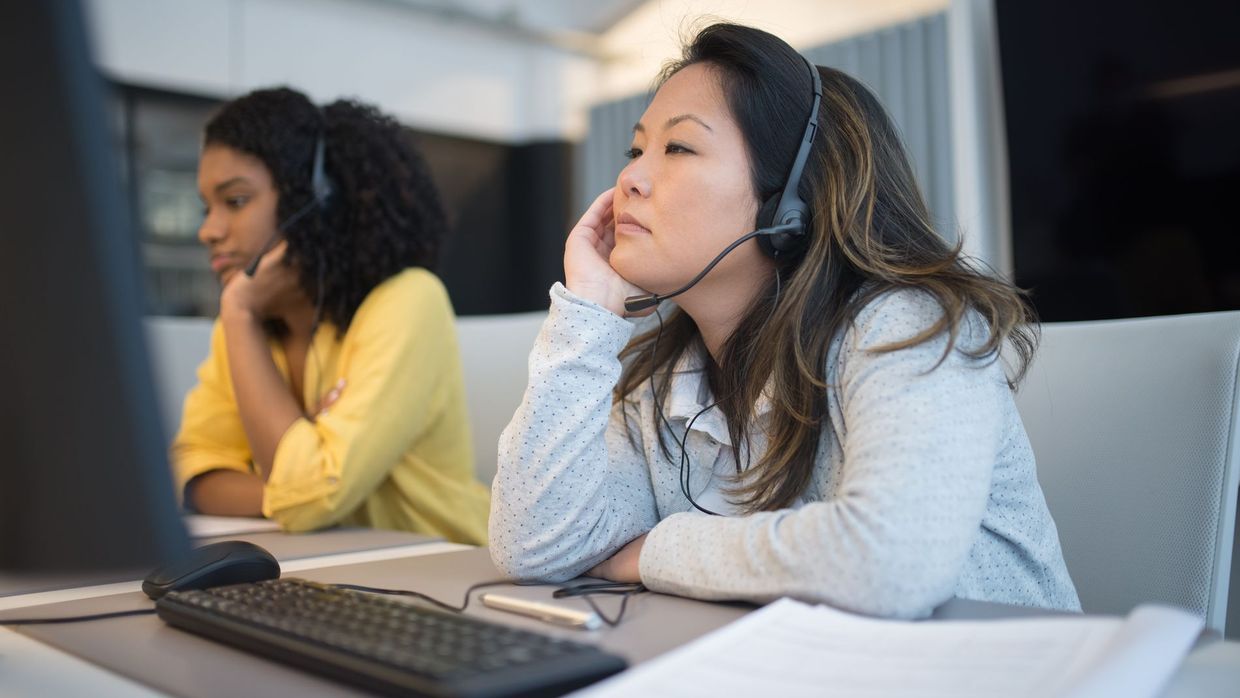 Contacting the site: focused customer support team using headsets at their desks in office environment