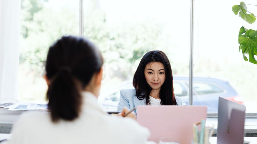 Two businesswomen engaged in a productive meeting in a modern office