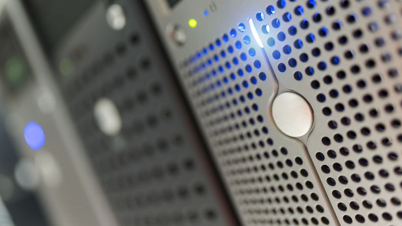 Focused detail of a modern server rack with blue LED indicators in a data center