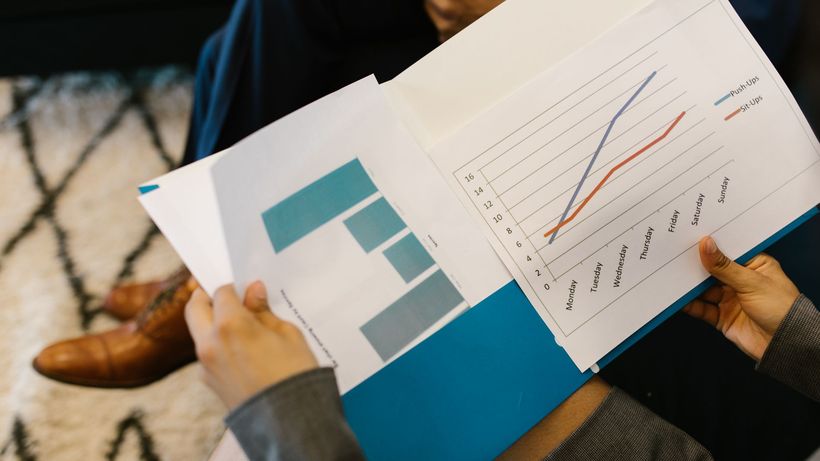 Detailed view of business reports with graphs during a corporate meeting