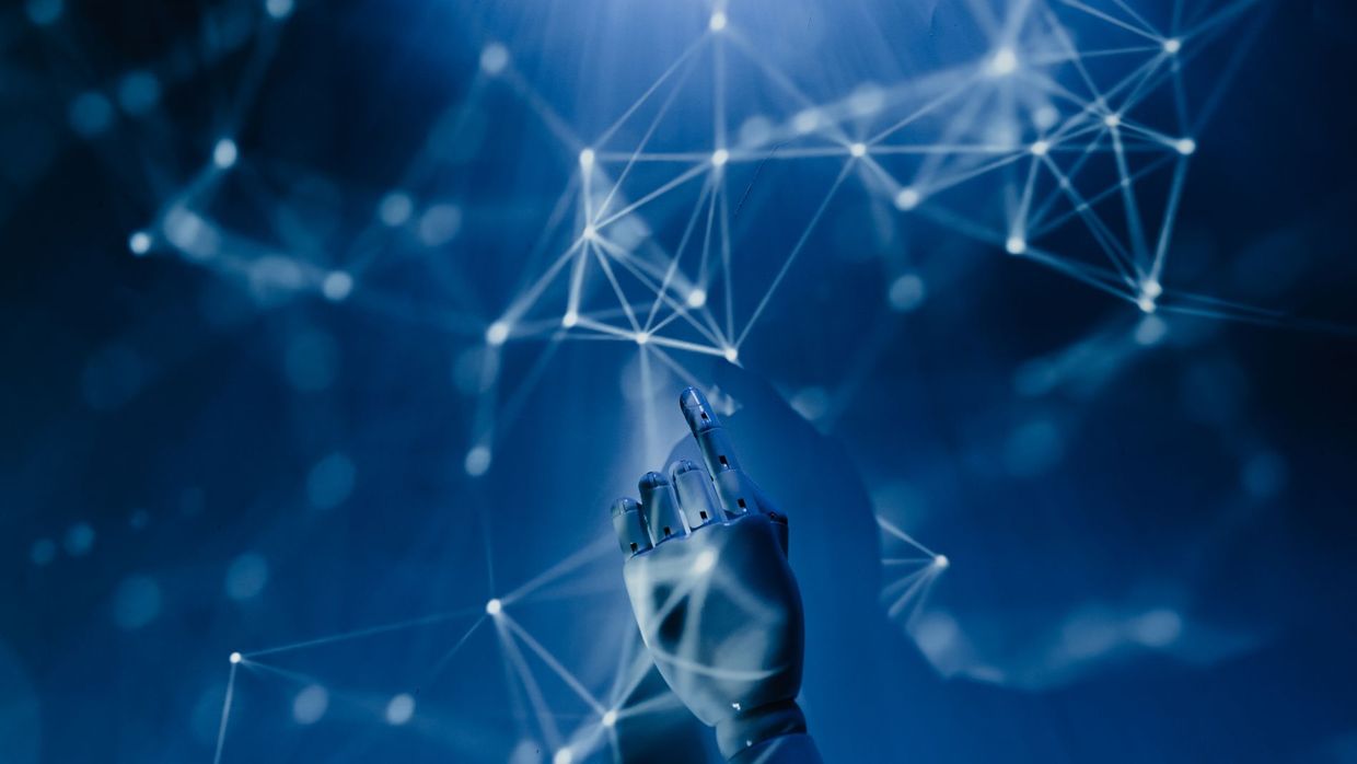 Generative engine optimisation: a robotic hand reaching into a digital network on a blue background, symbolizing AI