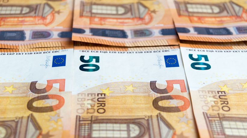Detailed image of multiple 50 Euro bills stacked, showcasing currency design