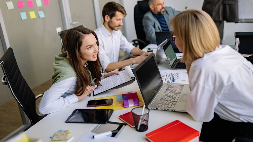 Team discussion in a modern office setting, focusing on cooperation and strategy development