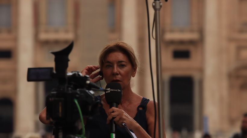 Journalist reporting live from Vatican City, capturing the essence of urban broadcast journalism