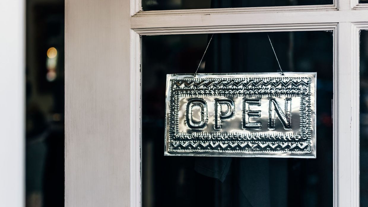 Local SEO: metal open sign hanging on a shop door in Paso Robles, California