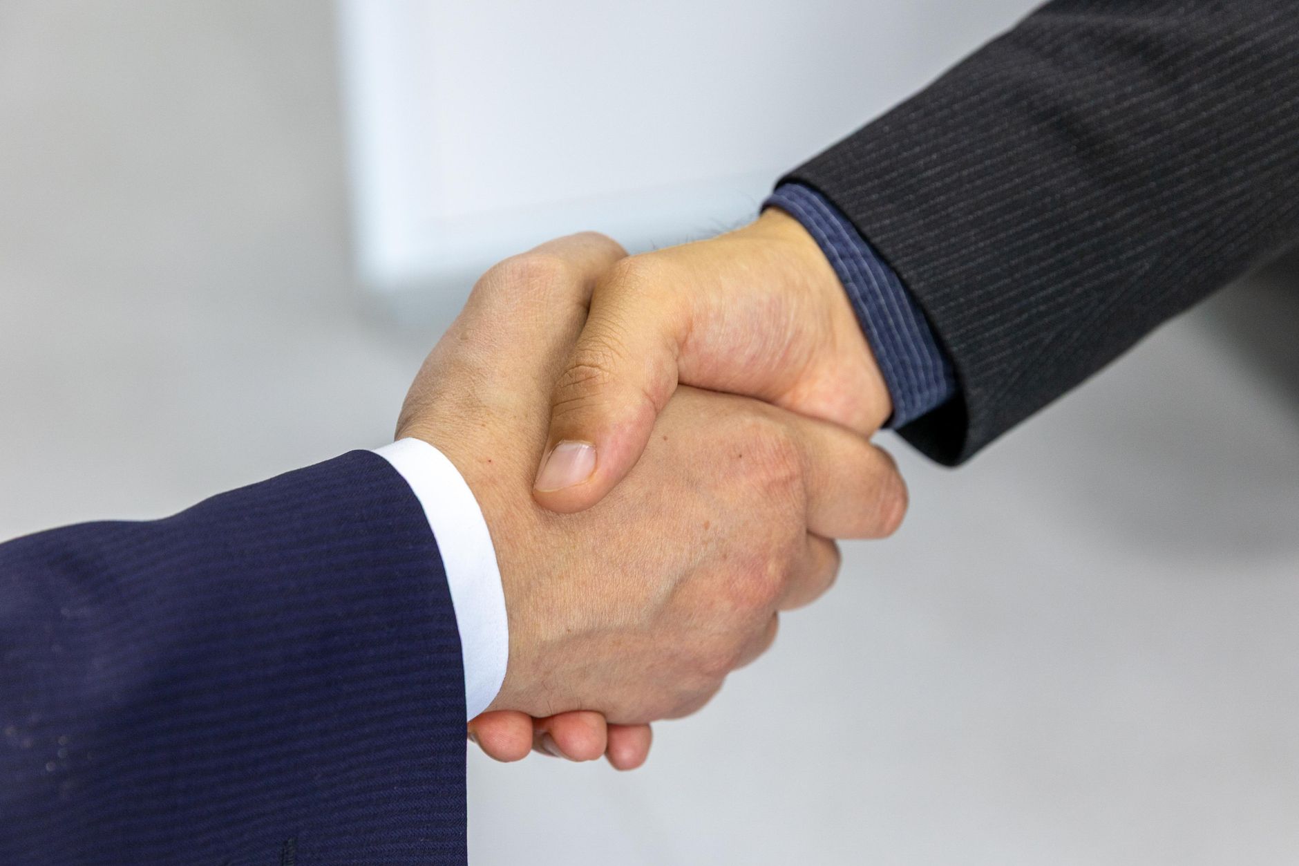 Professionals shaking hands after agreeing on pay
