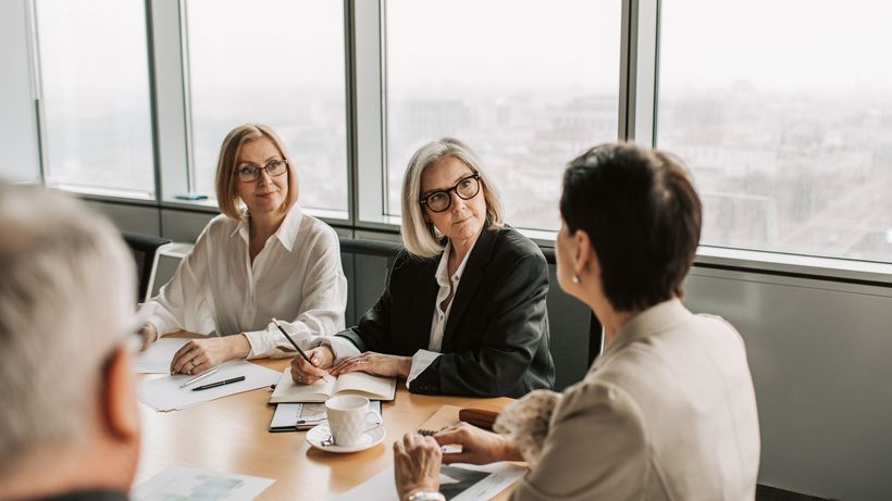 Business professionals engaged in a strategy meeting in a contemporary office. Daytime setting