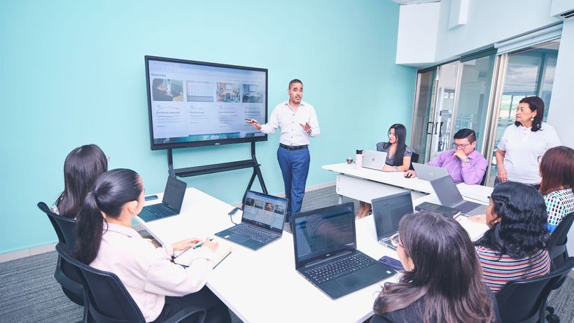 Team engaged in a presentation at a modern office using digital technology
