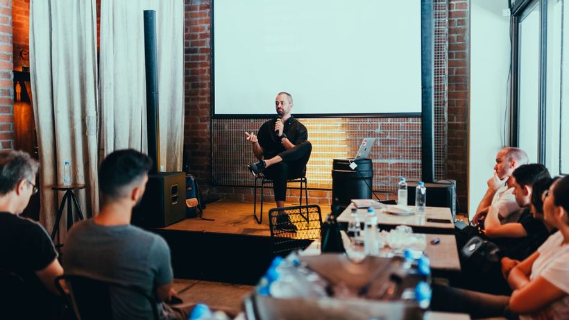 A business seminar with a speaker addressing an attentive audience in a modern conference setting