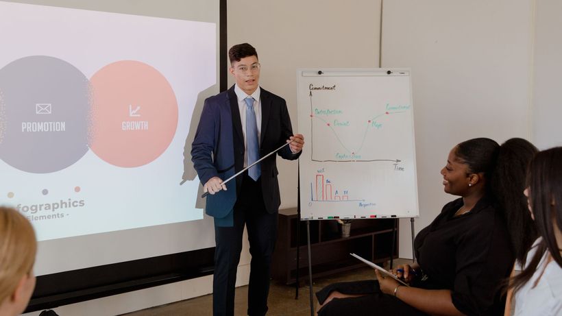 Young professional presents growth strategy using charts and graphs in a meeting