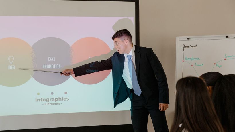 Professional giving presentation using infographic in an office meeting