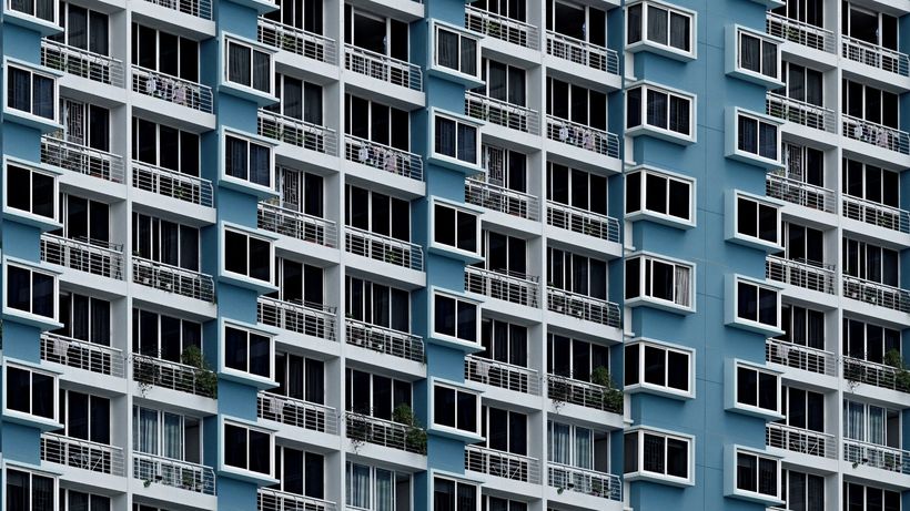 High-rise building facade with repetitive geometric window patterns in Singapore