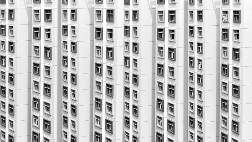 Symmetrical facade of a modern residential building in Singapore with repetitive window patterns