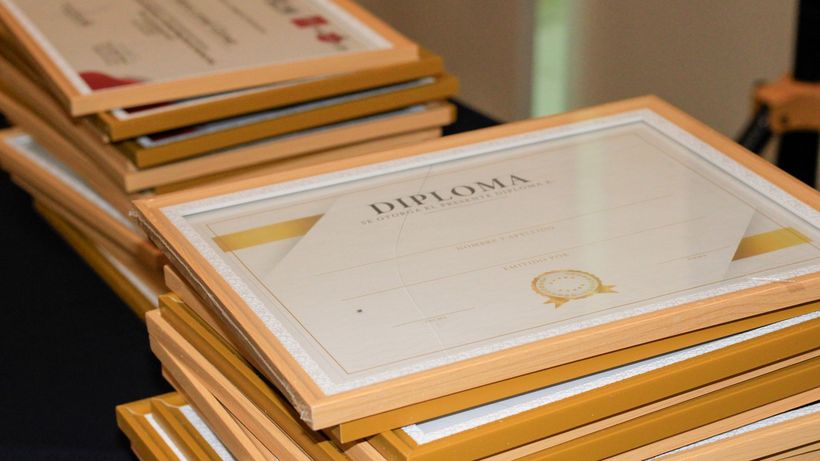 A stack of elegant framed diplomas prepared for an academic ceremony