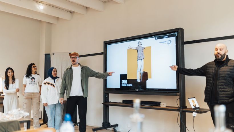 Diverse team delivering a digital presentation in a modern office environment