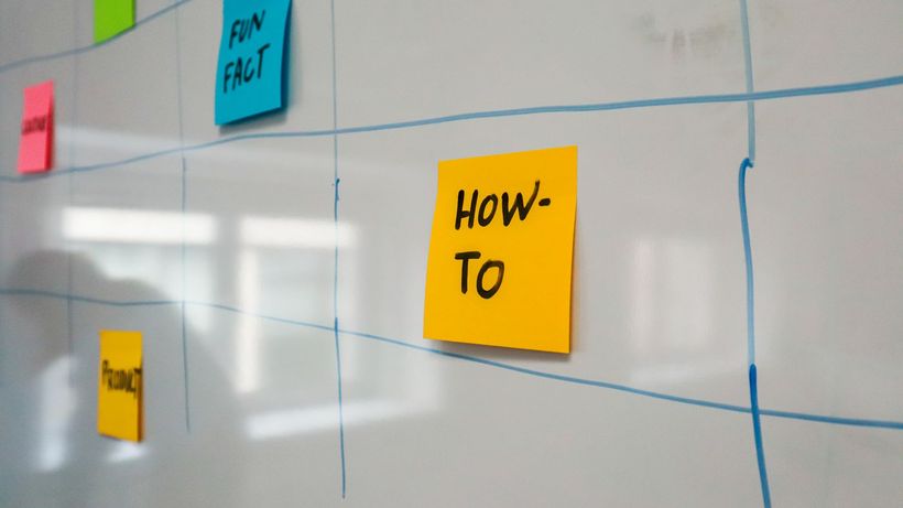Organized whiteboard with colorful sticky notes used for planning and brainstorming