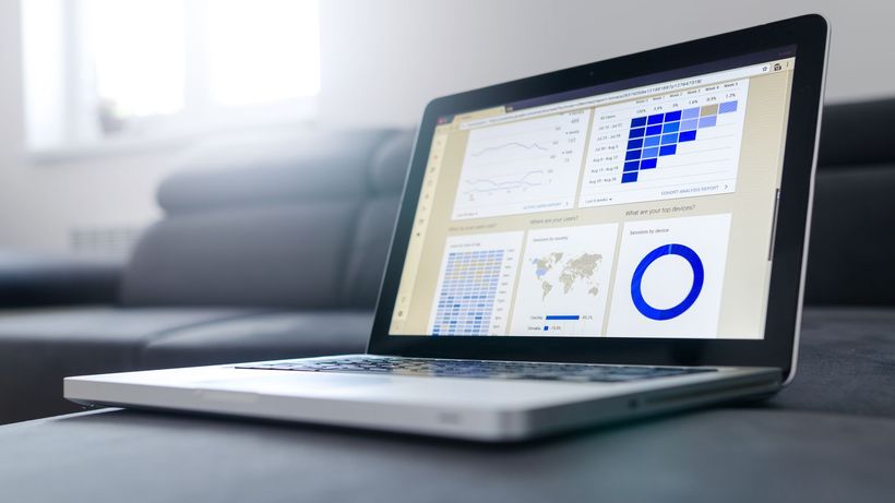 Sleek laptop showcasing data analytics and graphs on the screen in a bright room