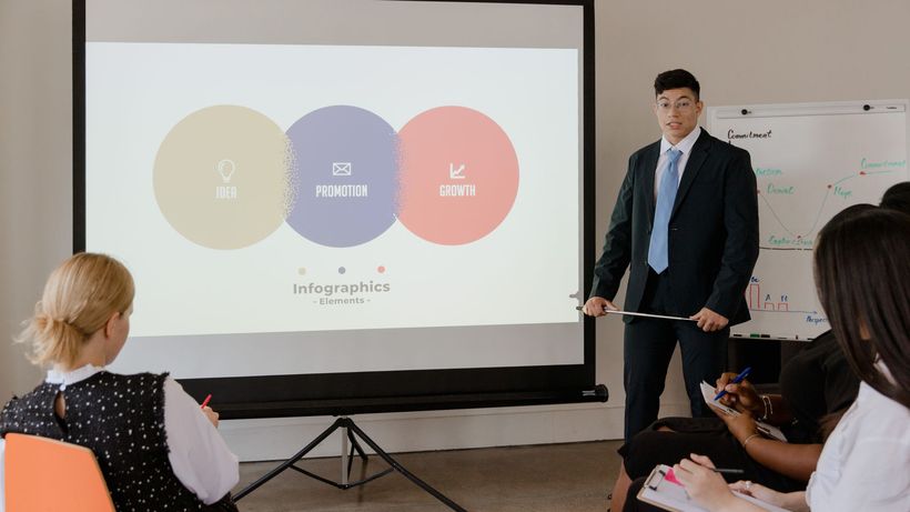 Professional business meeting with a presentation using visual infographics on a projector screen