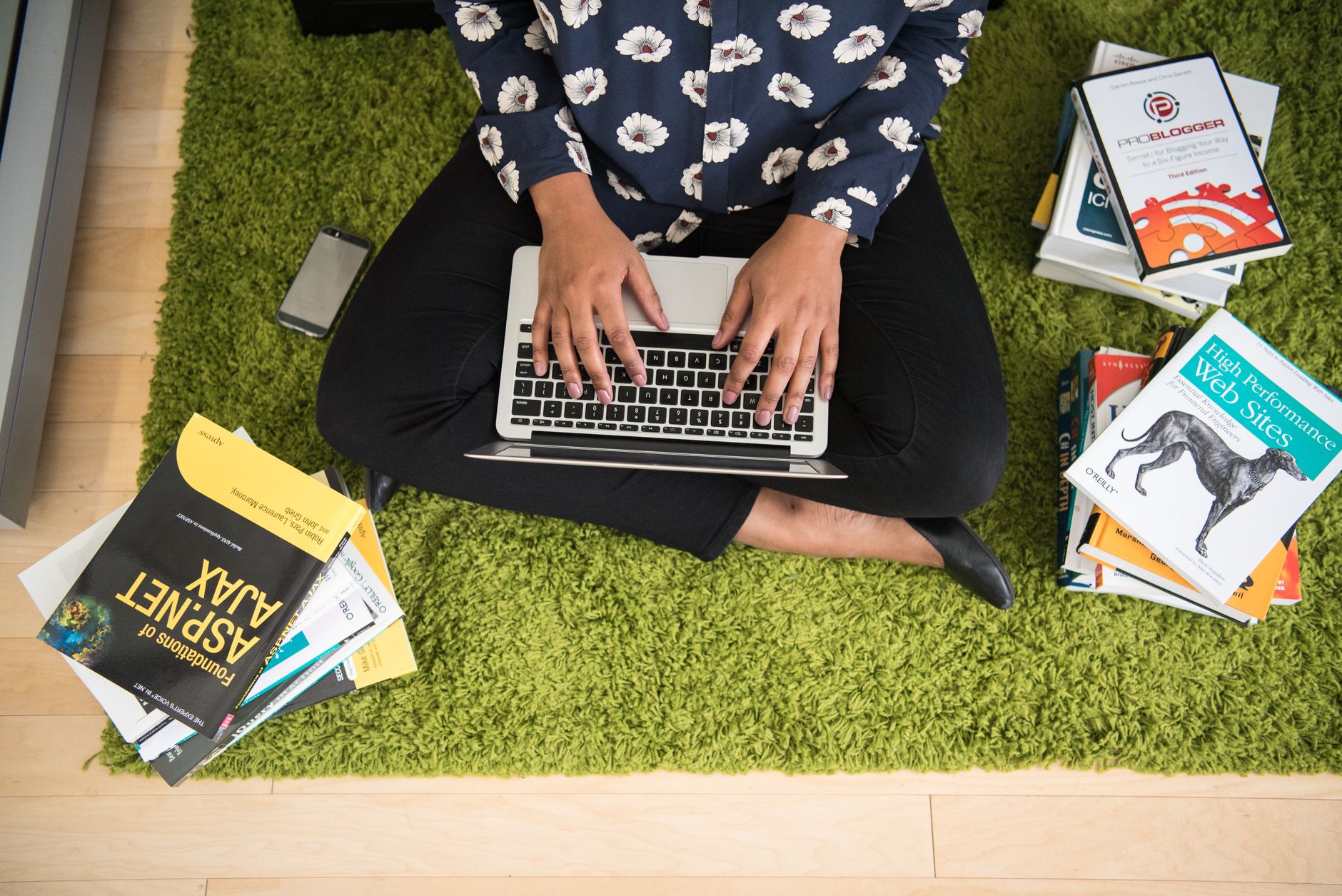 Studying SEO and web performance books beside a laptop