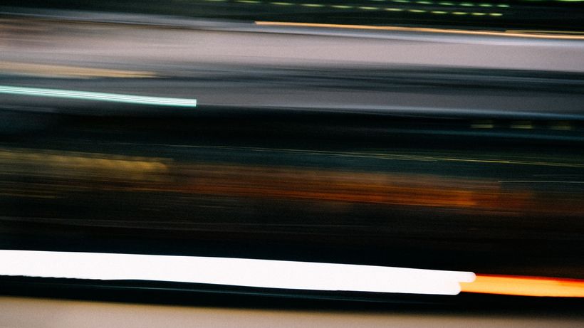 Blurred light trails captured at night, showcasing dynamic movement and abstract patterns