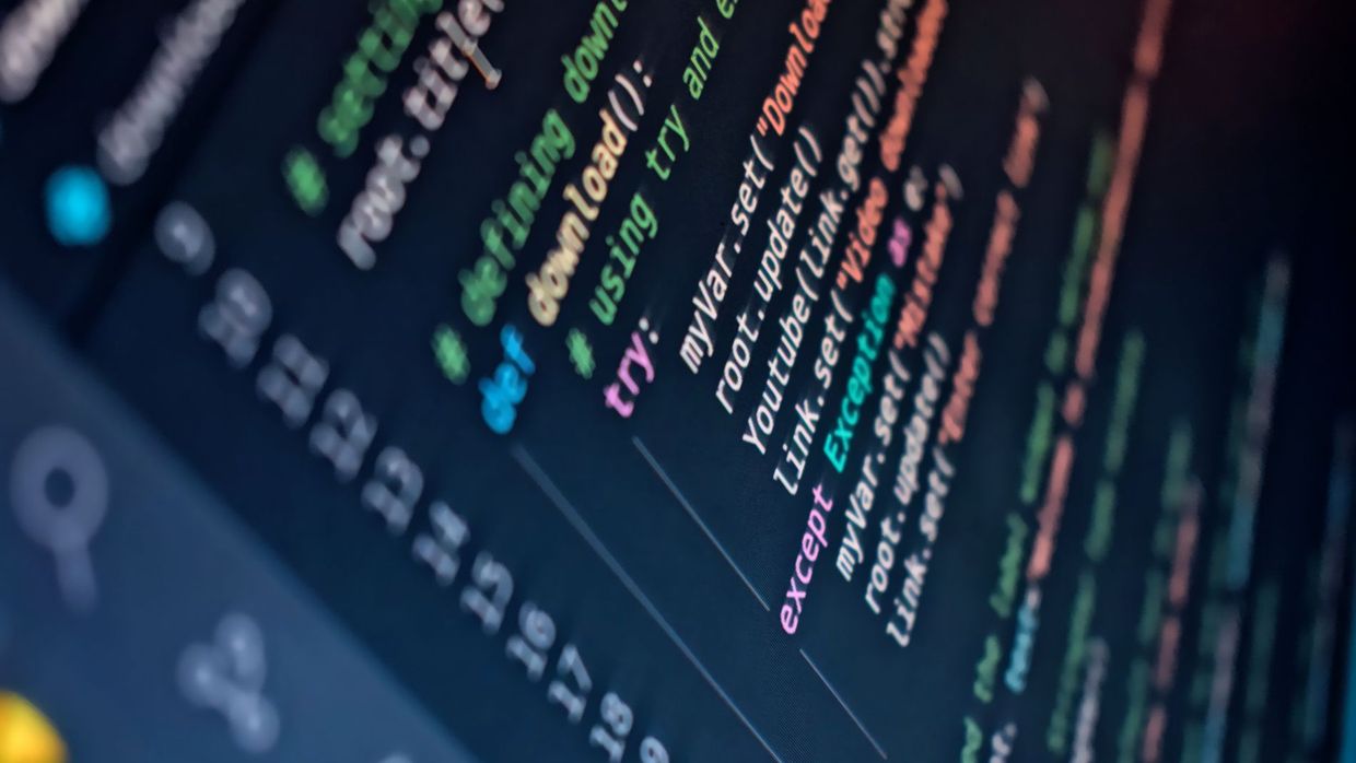 Technical SEO pay: close-up of a computer screen displaying colorful programming code with depth of field