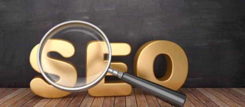 SEO word and magnifying glass promoting search for the best SEO jobs